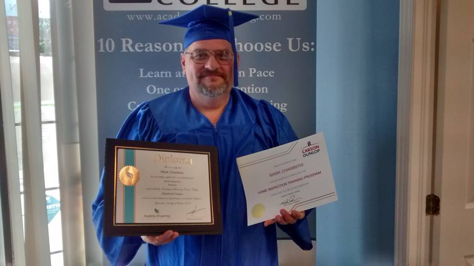 Graduate in cap and gown holding diploma and training certificate at Academy of Learning ceremony