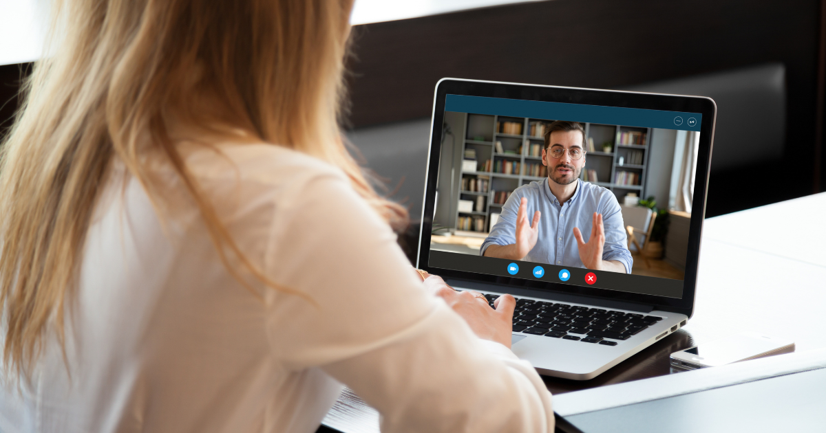 Job candidate conducting virtual interview on laptop with professional video call setup