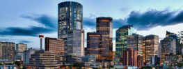 Downtown Calgary skyline with Calgary Tower and lit skyscrapers at sunset