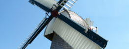 Historic windmill in Steinbach Manitoba under blue sky
