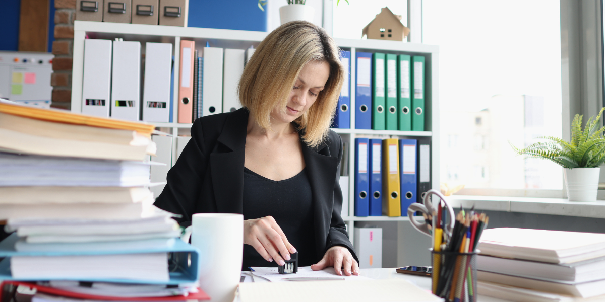 paralegal representing client Law clerk organizing case files and legal documents at office desk demonstrating daily tasks of legal administrative work