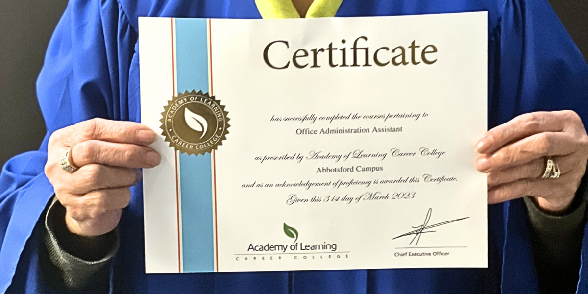 Student holding their certification