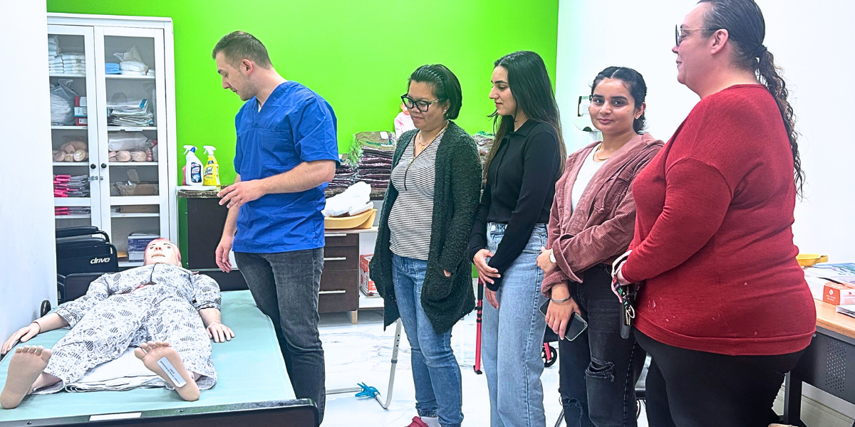 AOLCC students actively participating in a health & wellness course, developing hands-on skills essential for a successful career with a health care diploma.
