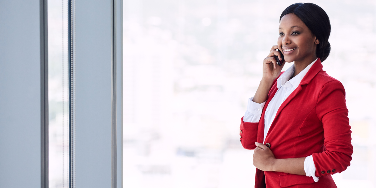 A woman confidently wearing a bold red sport coat, using the power of red as an accent to convey energy and passion in a professional setting.