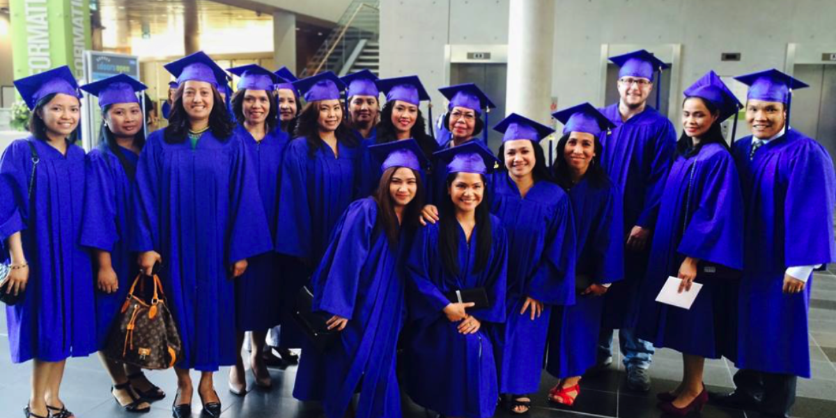 A diverse group of AOLCC graduates enjoying their graduation day, reflecting the success of targeted career training in British Columbia.