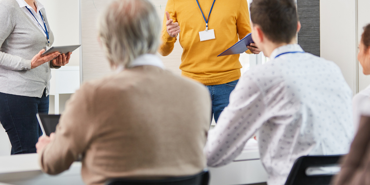 Group of individuals participating in a career training course to develop new skills during unemployment.