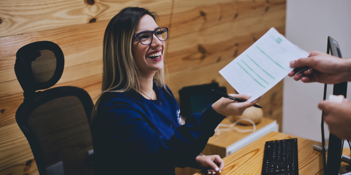 A dental administration assistant scheduling a patient’s appointment, a role supported by a one-year certificate program.