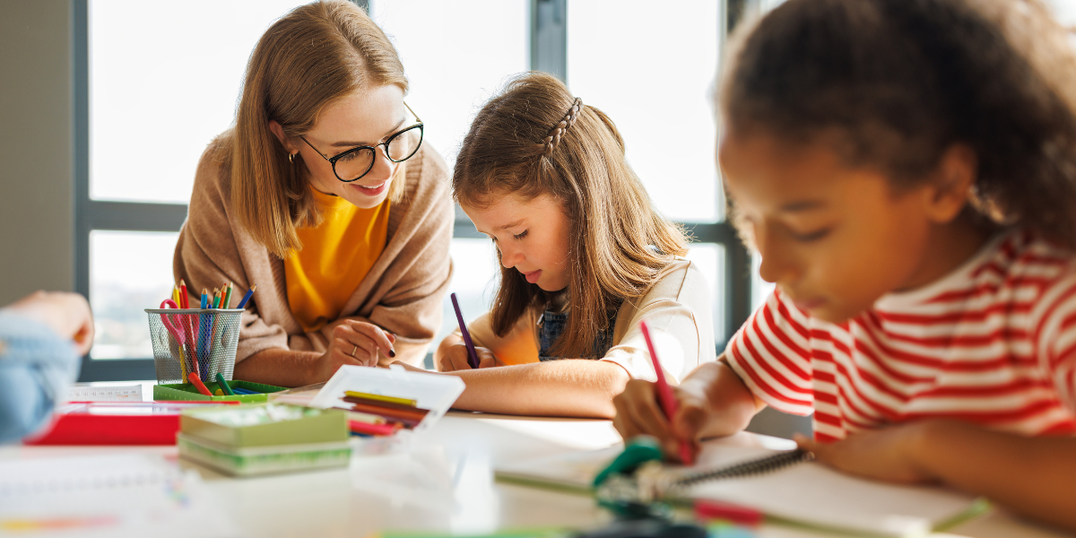 An educational assistant helping a student with remote learning, illustrating training from a one-year certificate program.