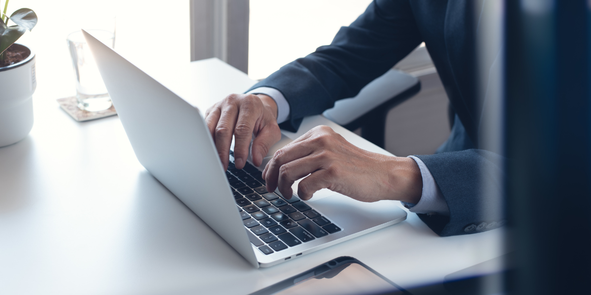 employees in microsoft office training Business person in formal attire typing on laptop in bright office space, demonstrating workplace efficiency enabled by Microsoft Office productivity tools.